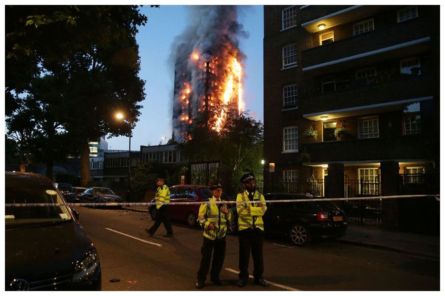 Police block traffic as a huge fire engulfs the Grenfell Tower.