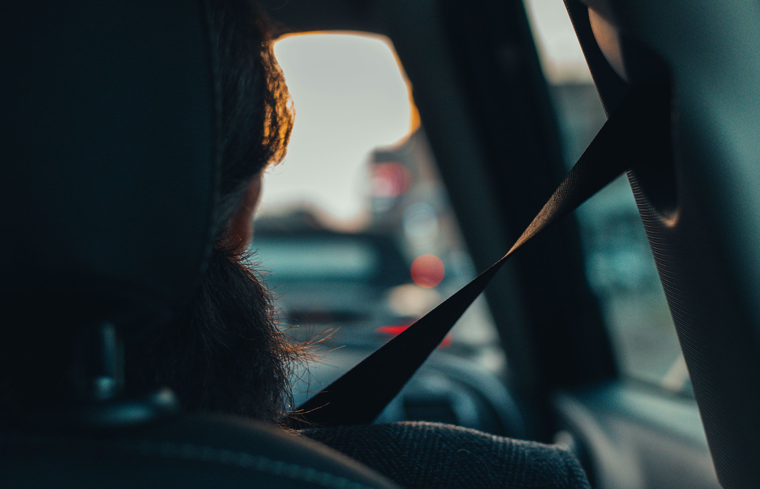 Image of woman driving taken from behind.