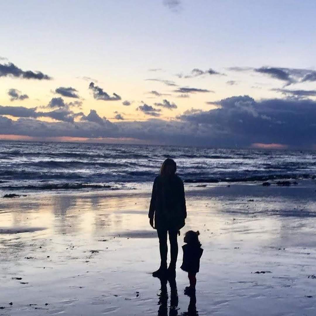 An image of Dr Wenger and her daughter Nina on the beach.