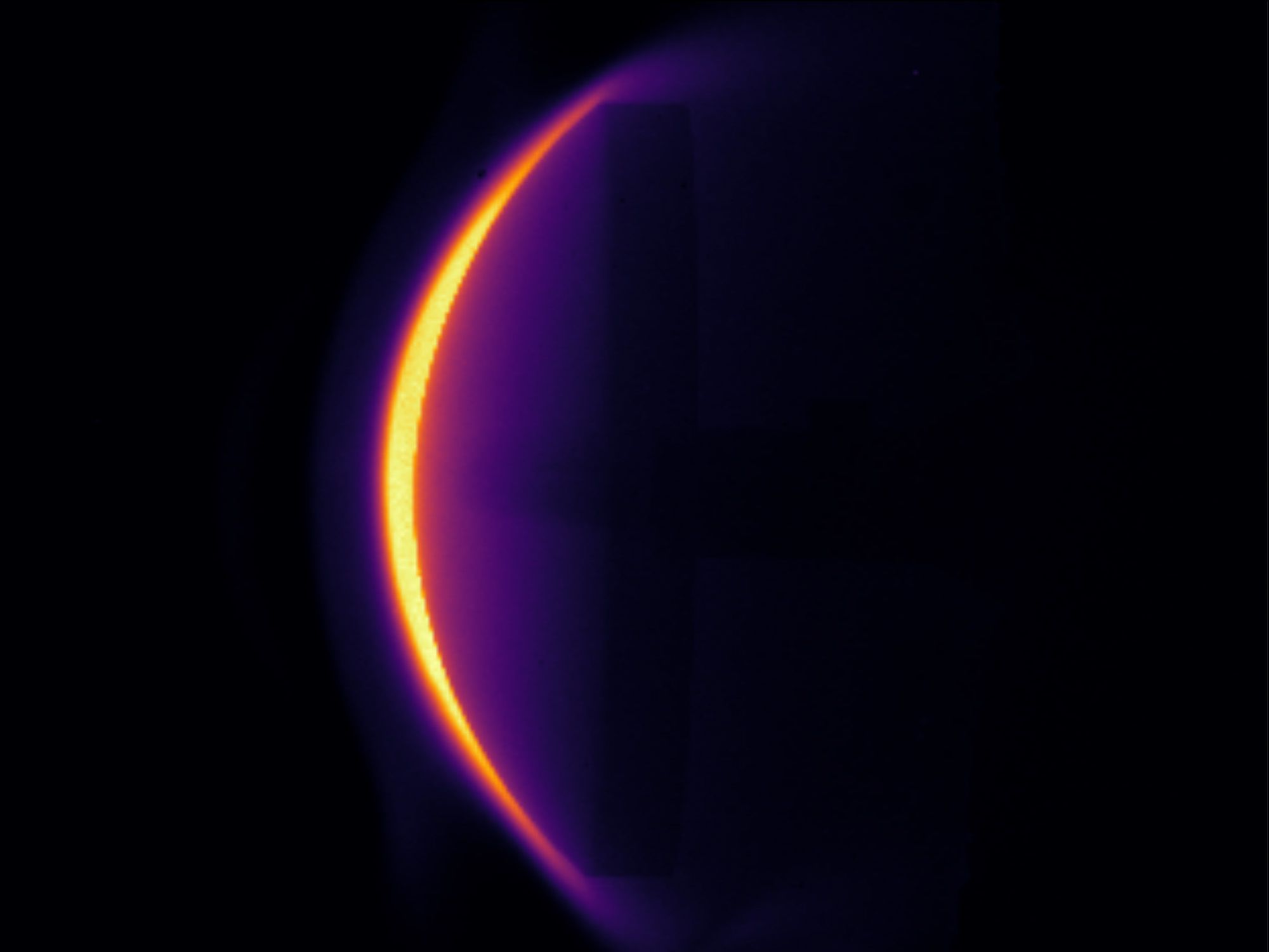 A glowing, curved shockwave on a black background.