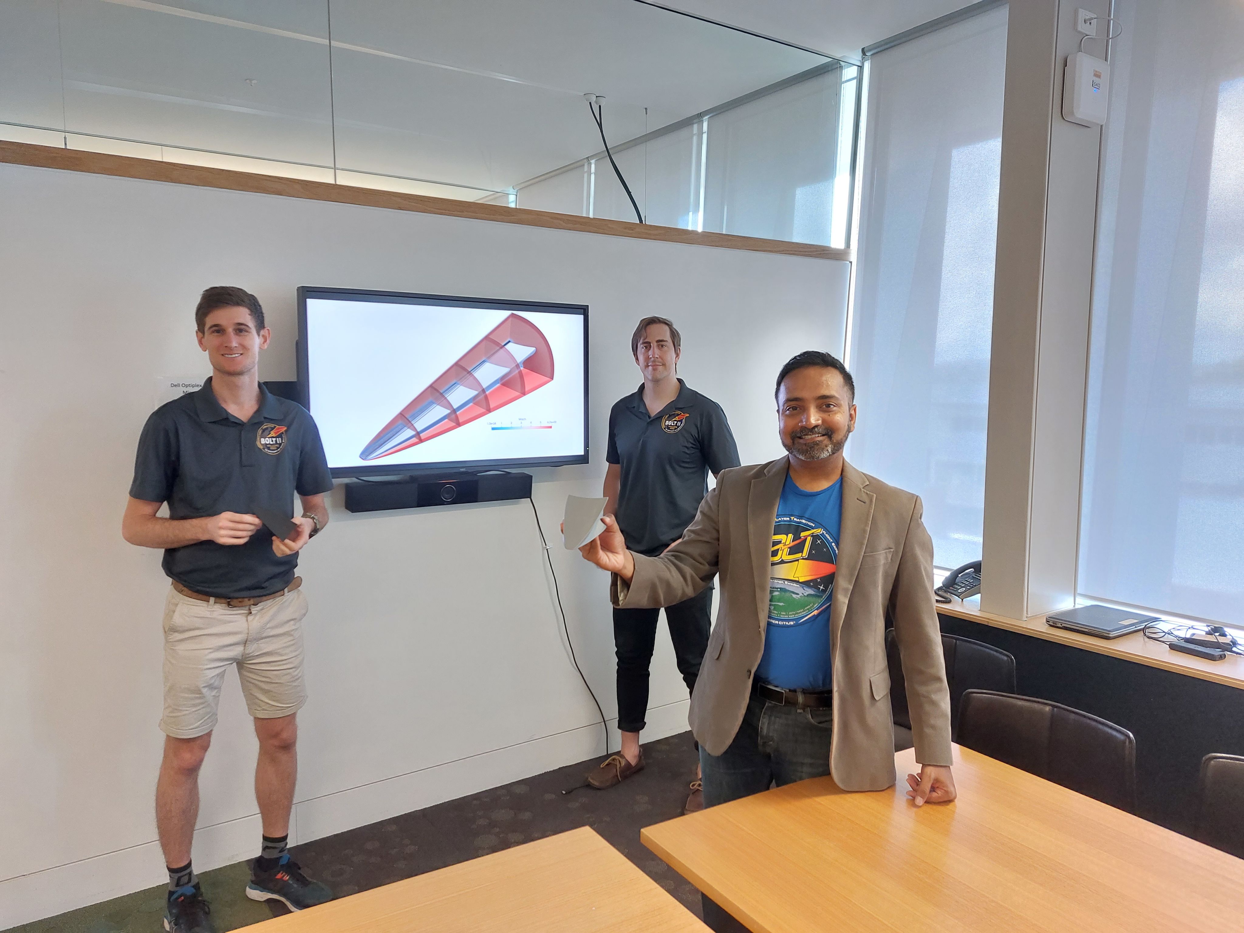 Associate Professor Veeraragavan (right) with Dr Will Landsberg, postdoc for UQ’s ground-tests (left), and Dr Kyle Damm, postdoc for UQ’s heat transfer simulations (centre), displaying the simulations done at UQ and a small version of the BOLT II model. Absent: Dr Damian Curran, postdoc for simulations support, and Mr Lachlan Whyborn, direct numerical simulations.