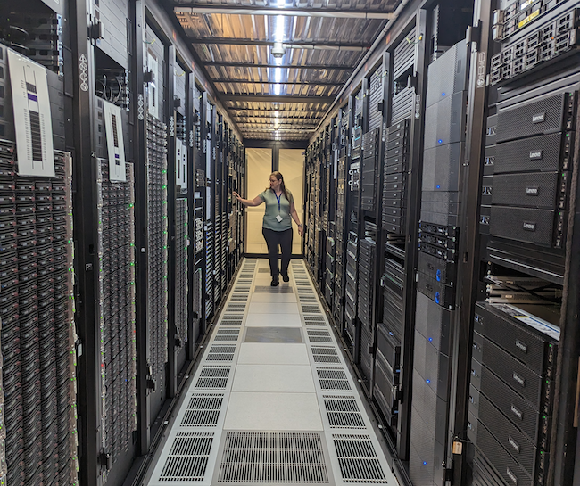 Woman walks among supercomputers