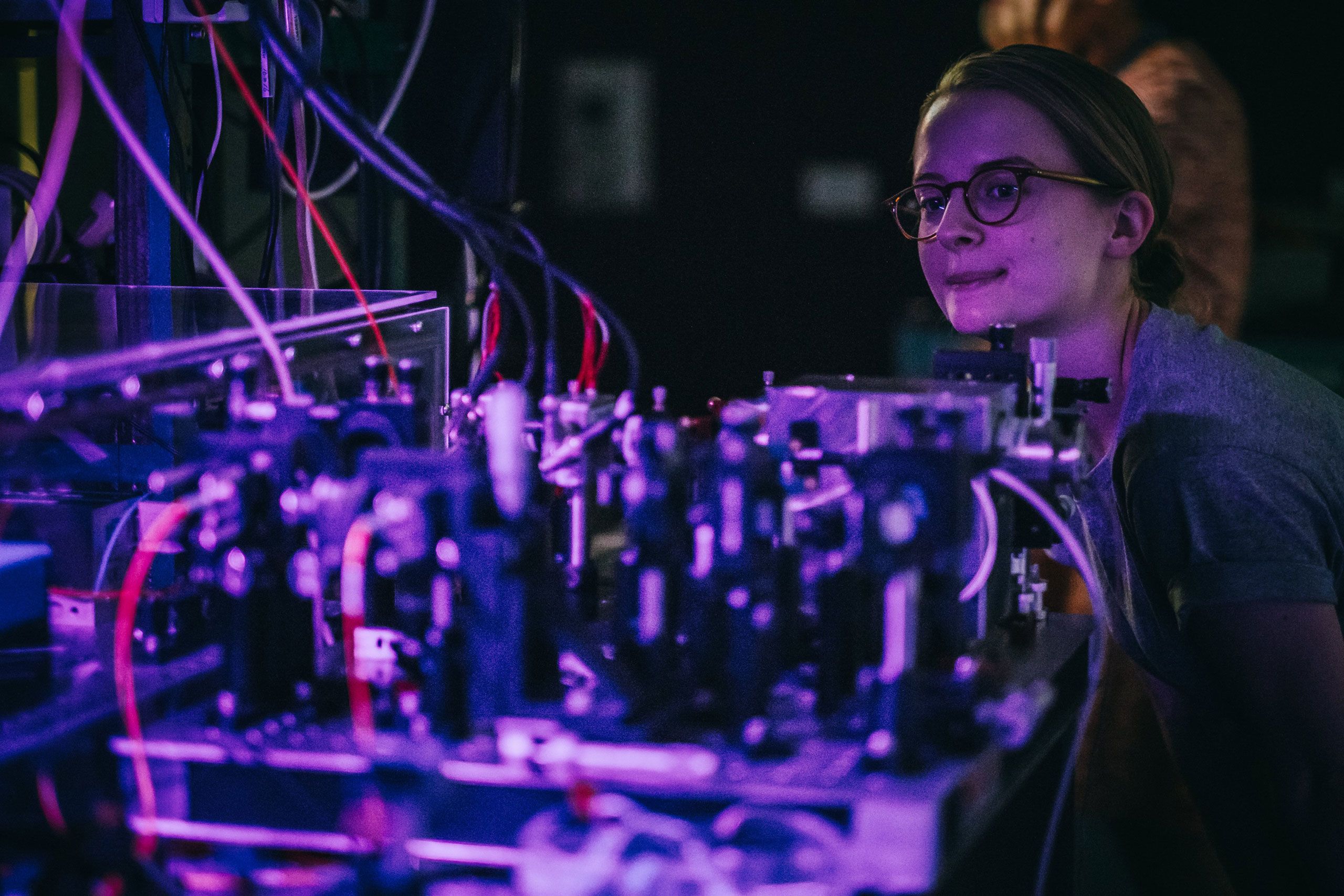 A UQ student works with computer parts in UQ’s Superconducting Quantum Devices Lab.
