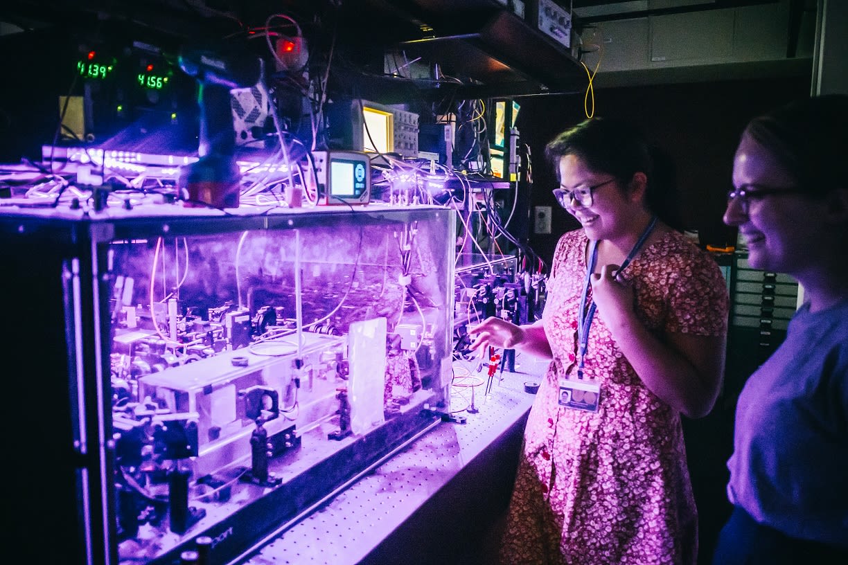 Two UQ students are working with computer parts in UQ’s Superconducting Quantum Devices Lab.