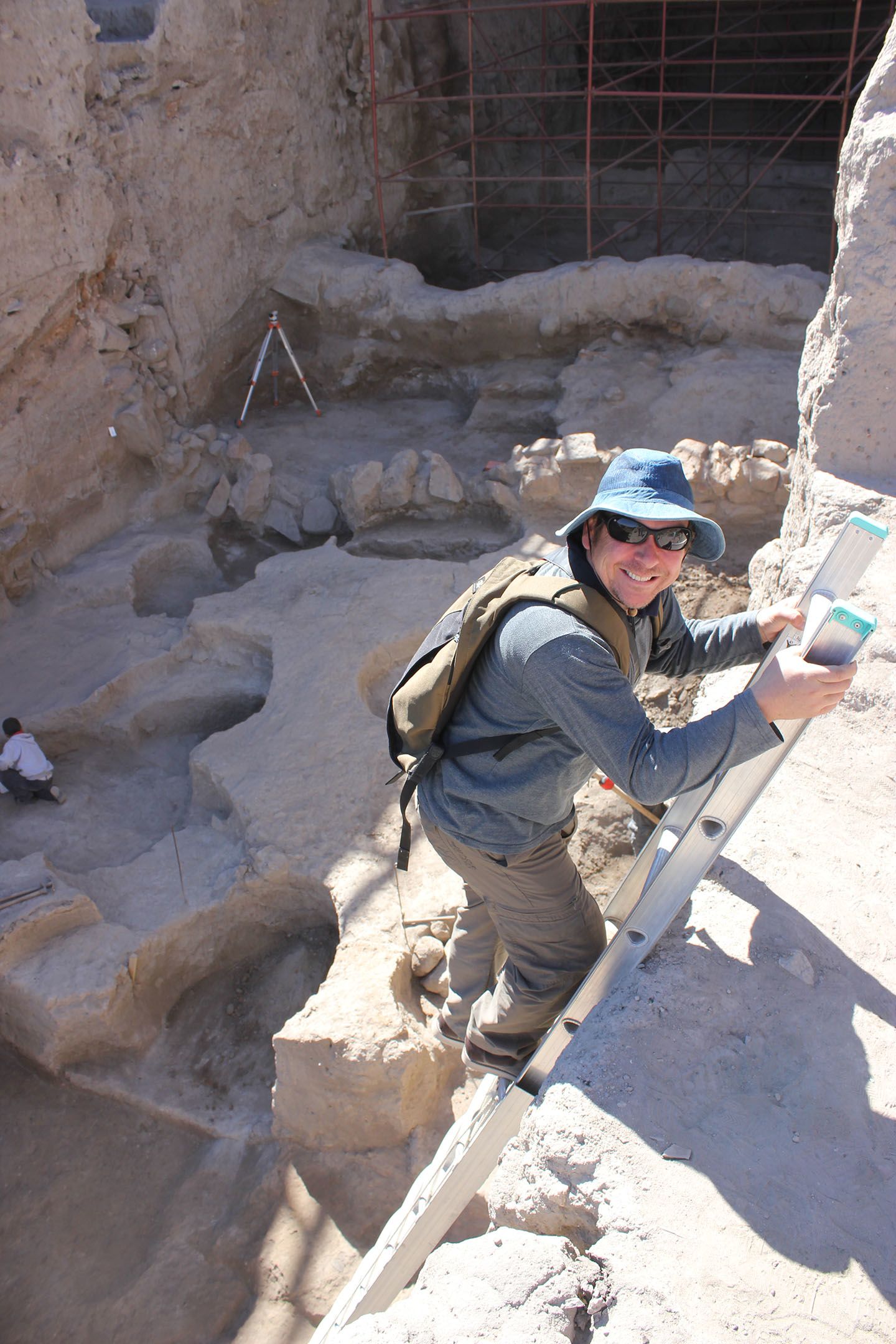 Researcher Steve Chaddock descends a ladder on an archaeological dig