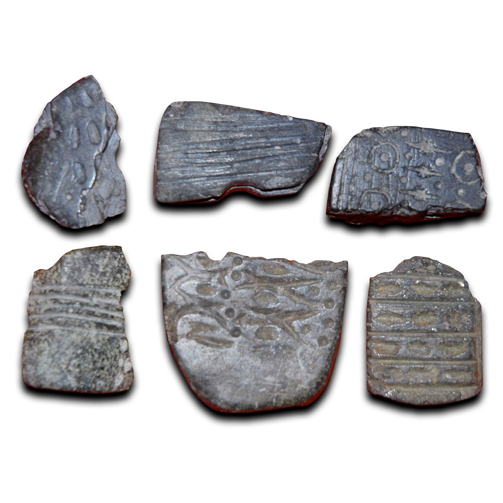 Six flat stones inscribed with Neolithic art patterns