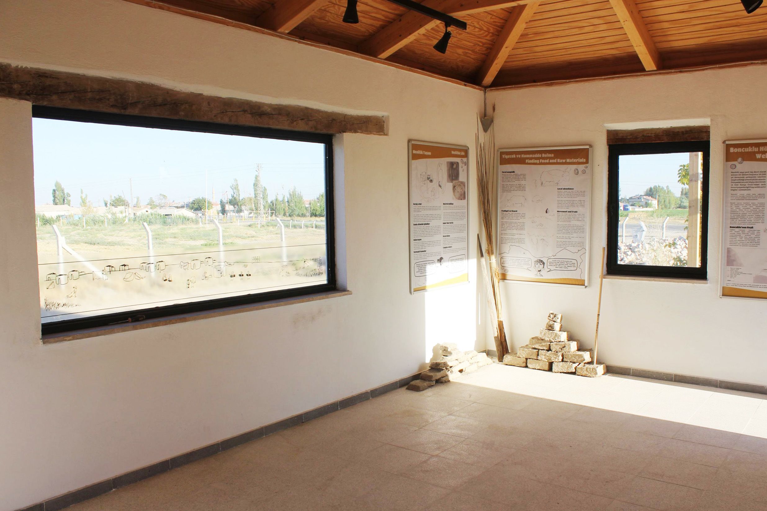 The inside of a bright room with large windows and big text panels on the walls