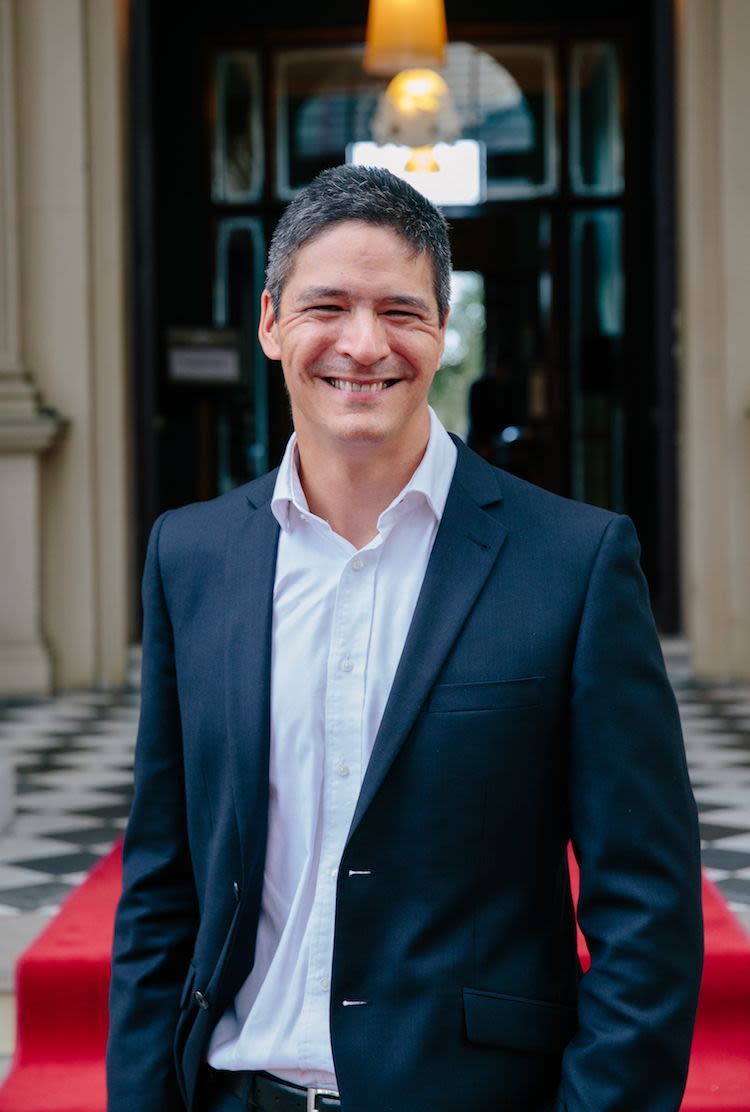 Professor Mark Horswill. A man wearing a white collared shirt and black jacket. He has salt and pepper hair and is smiling.