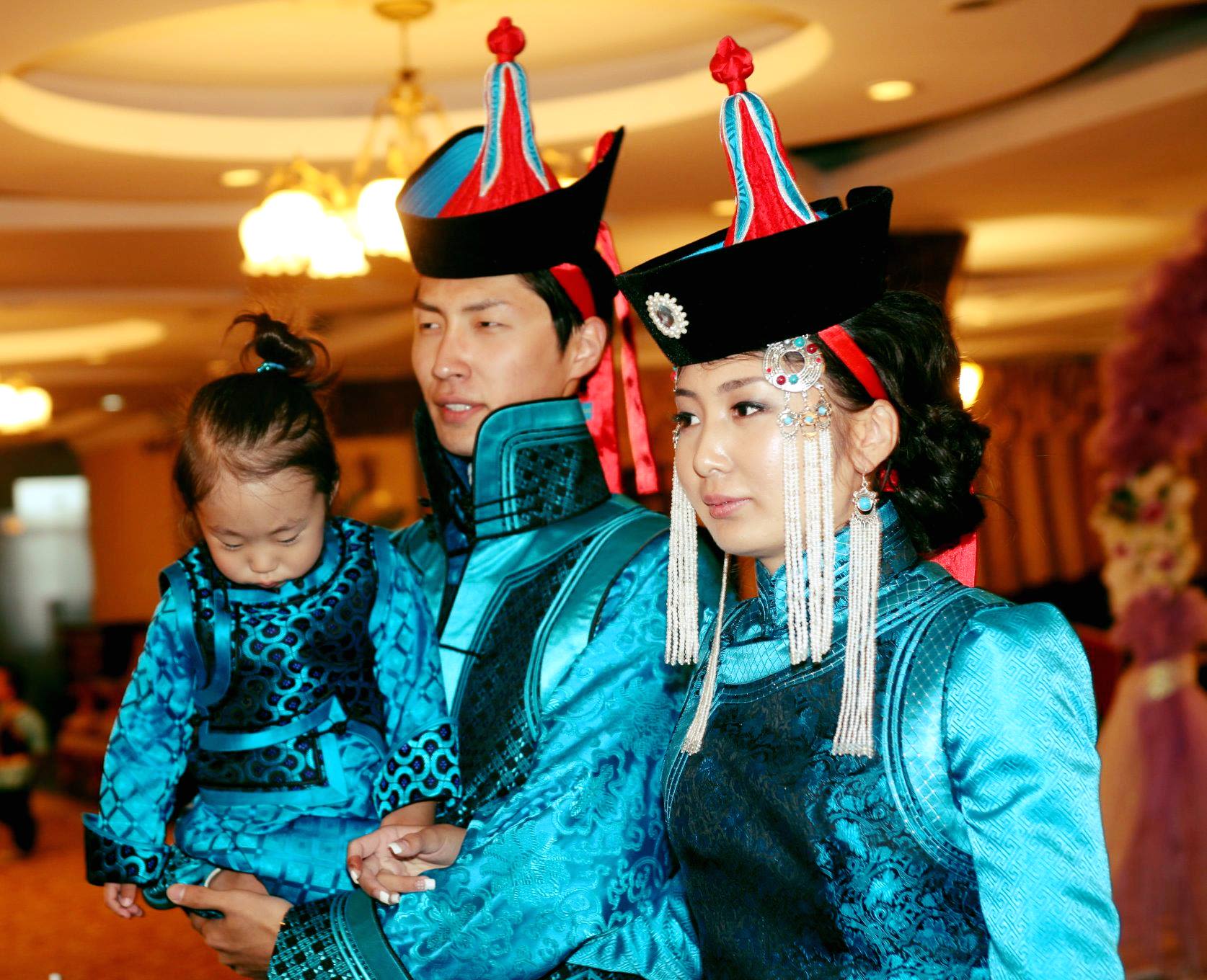 Saka with his wife and daughter in traditional dress at their wedding.