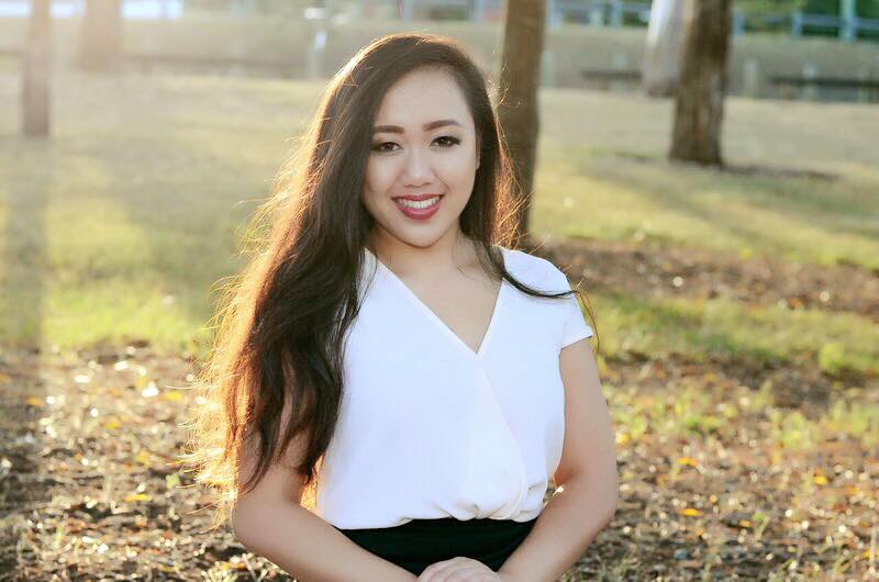 Nina Sackprasith smiling. She’s standing in a park.