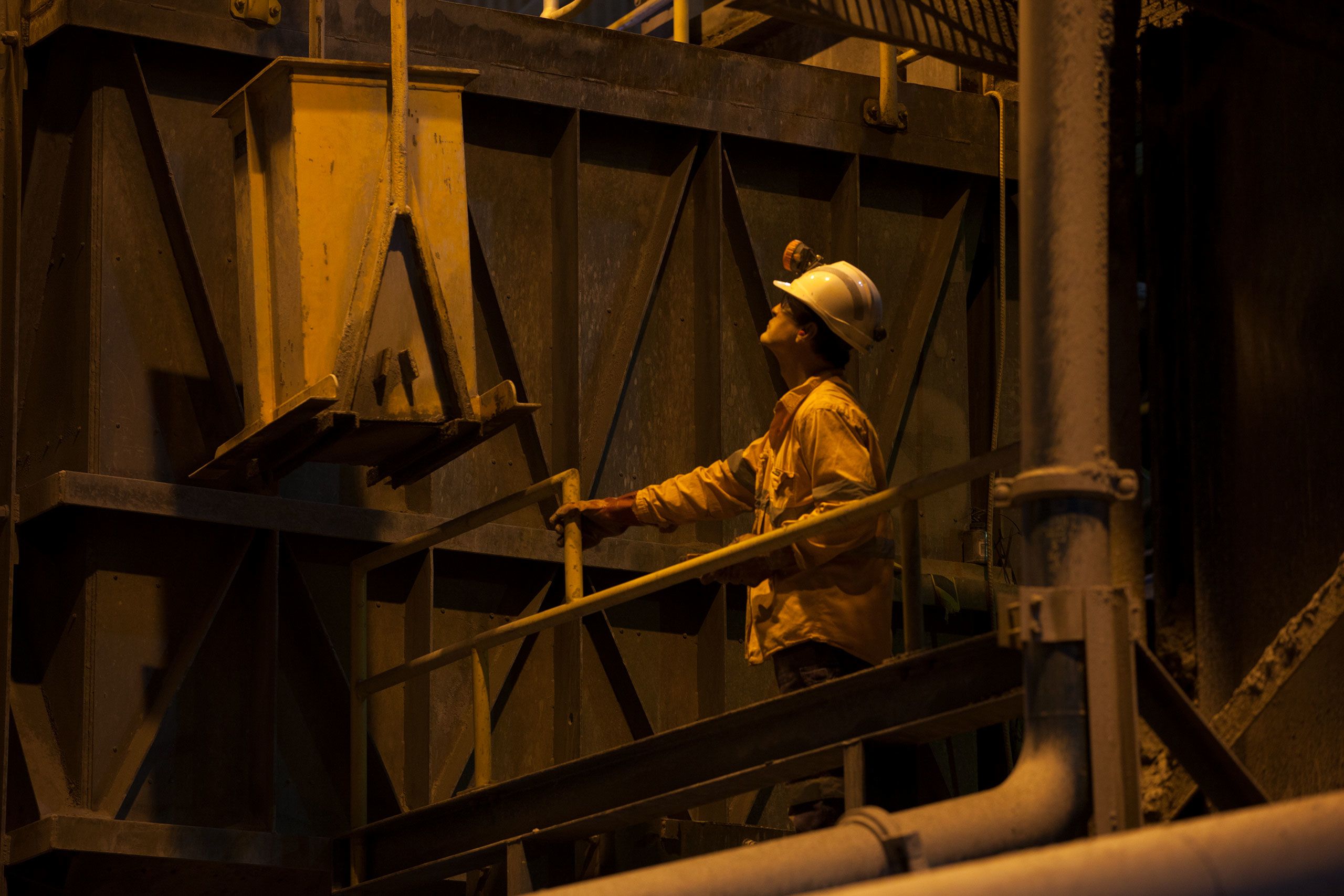 Worker looking up at equipment
