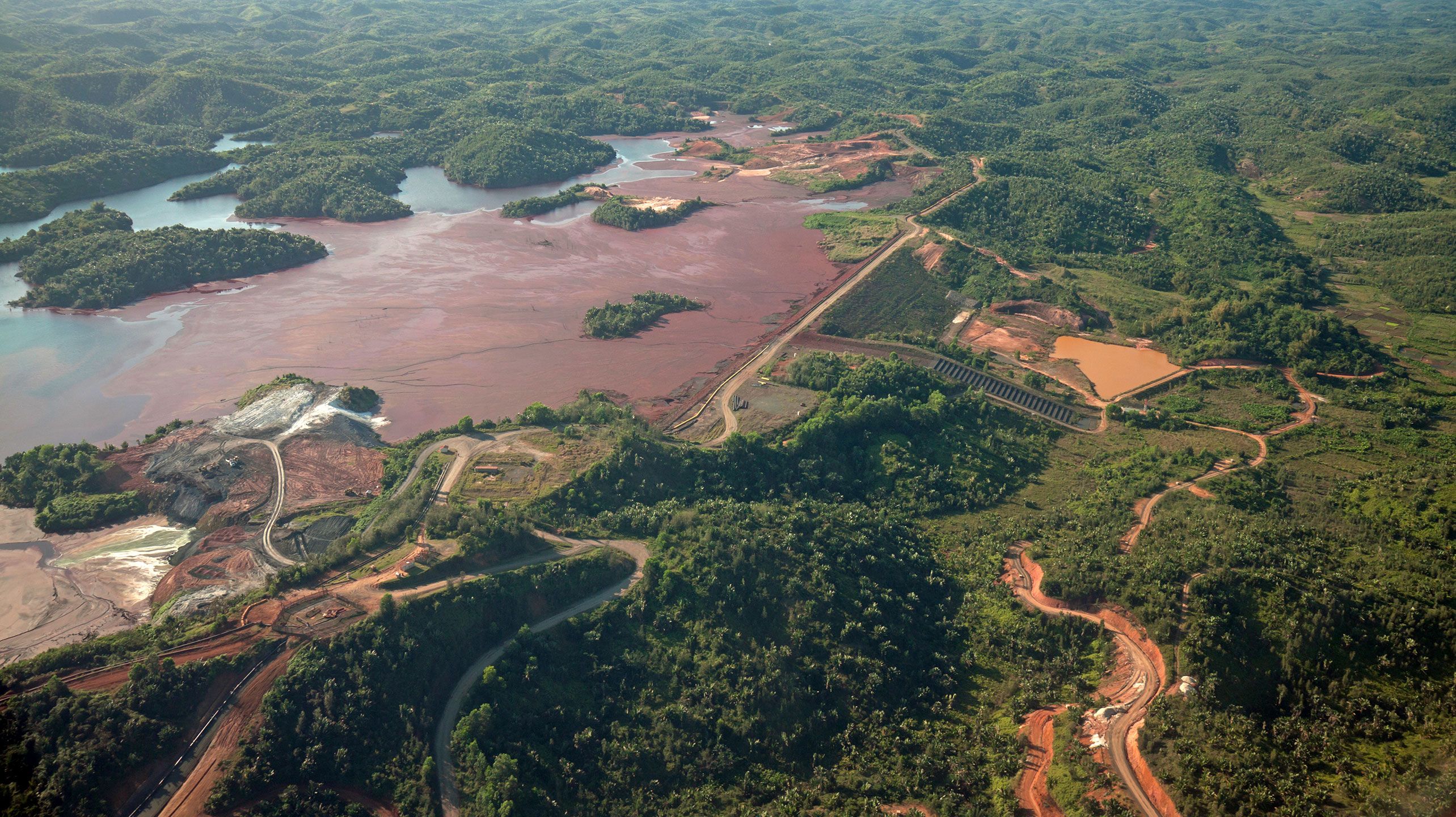 Mine tailings reservoir in Africa, receiving slurry through a pipeline from an ore processing plant.