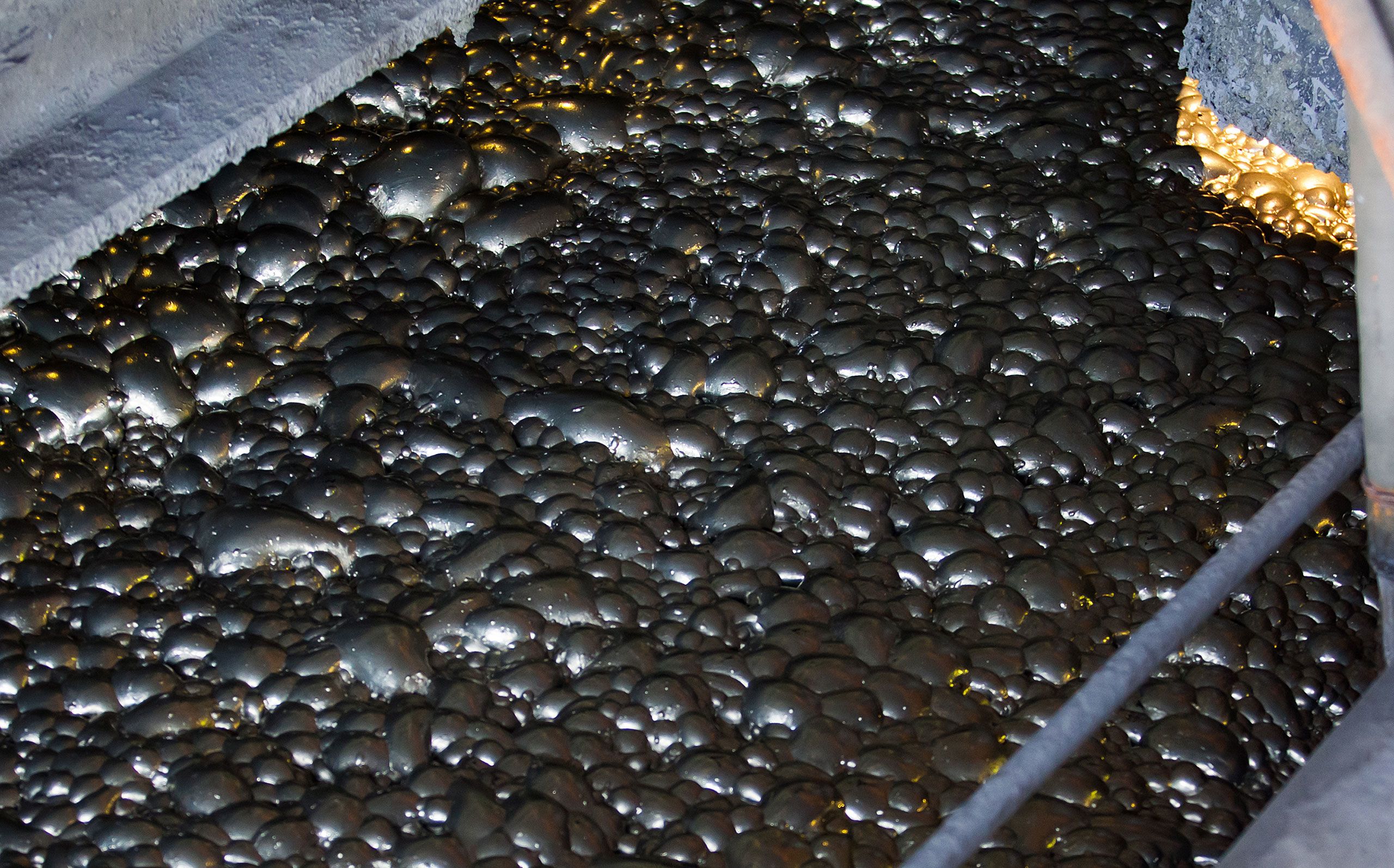 Copper concentration plant. Ore flotation and processing. Close-up of fine pulp with bubbles.
