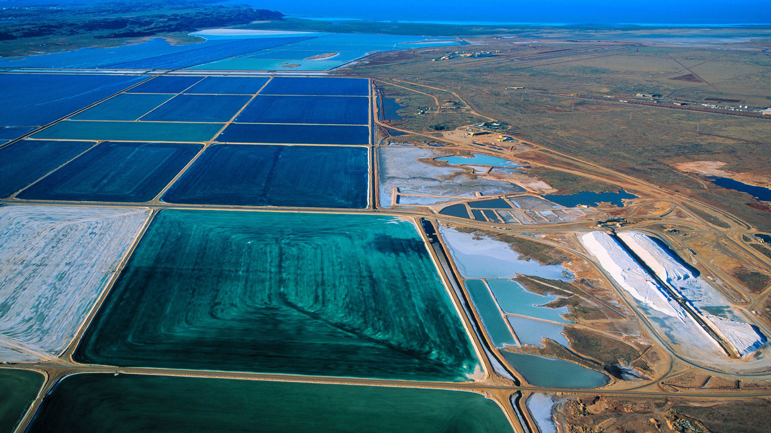 Salt mining at Dampier Western Australia, showing the dyed salt ponds to help water evaporate.