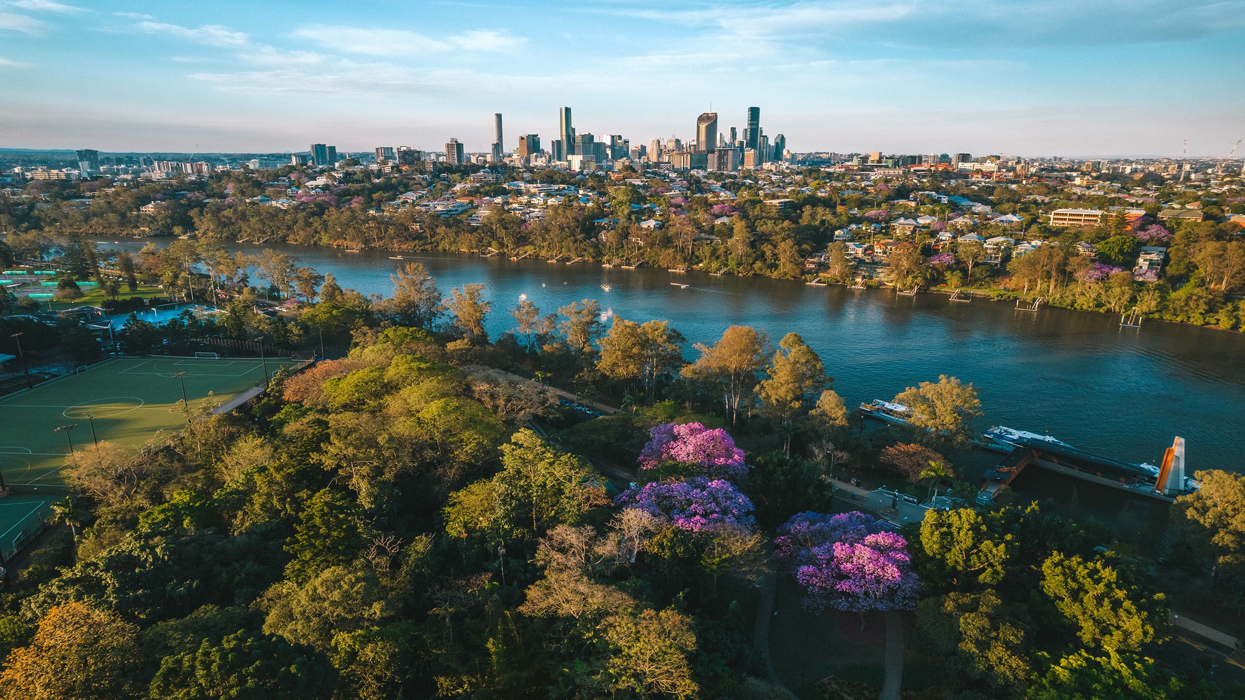A aerial view of University of Queensland St Lucia campus, the Brisbane River, and the Brisbane CBD